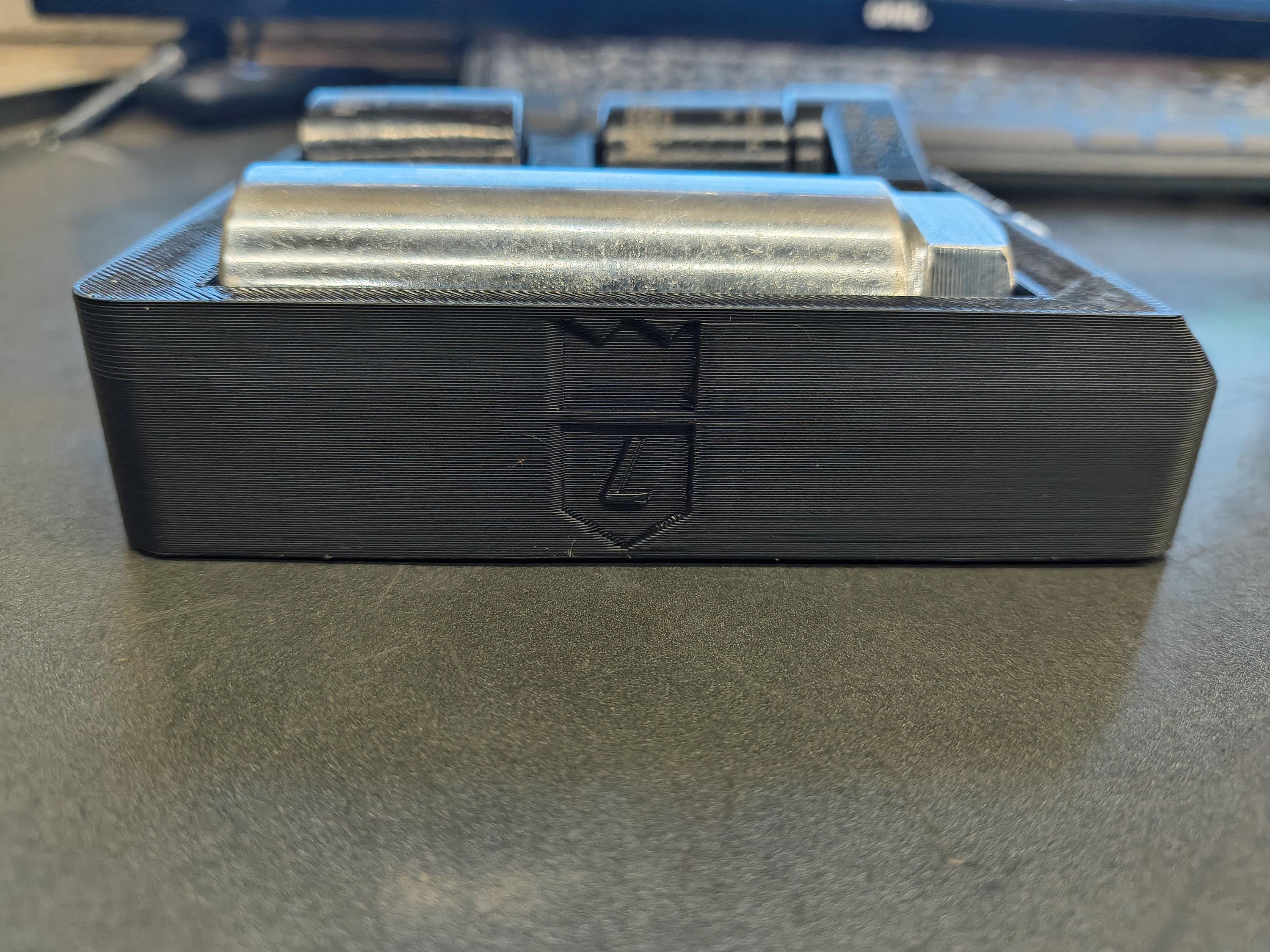 Black and blue electronic device with metallic components on a white background